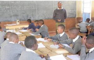 A clear photo of a teacher handling cbc learners in a classroom in Northern Kenya 