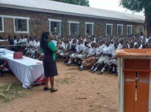 A clear photo of a deputy principal of a school in Eastern Kenya addressing learners during a school closing ceremony 