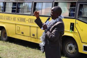 Honorable Julius Melly, the education committee chairman while addressing teachers and learners of Kapsiligai school during prize awards day