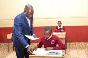 A clear photo of President William Ruto distributing KCPE papers to learners in a school in Nairobi County on November 2023 